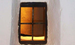 Andalucian window in whitewashed house .